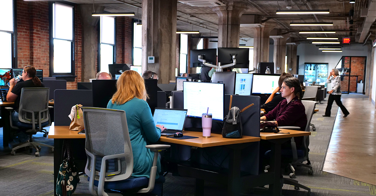 Several TriComB2B women working in new, open office space at The Manhattan building