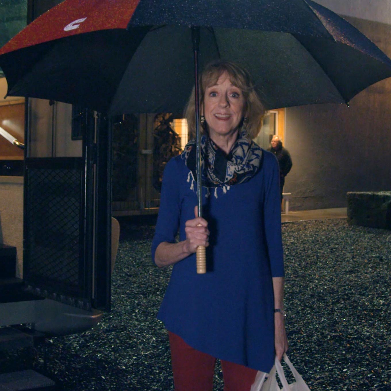 Spokewoman talking under umbrella