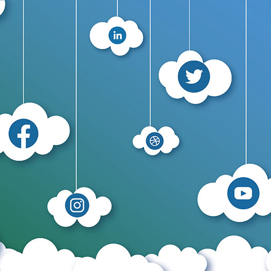 Cropped, five clouds with social media logos held up by strings on a blue, green background.